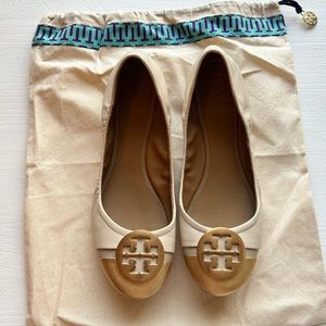 Tory Burch nude ballet flats with with gold cap toes.